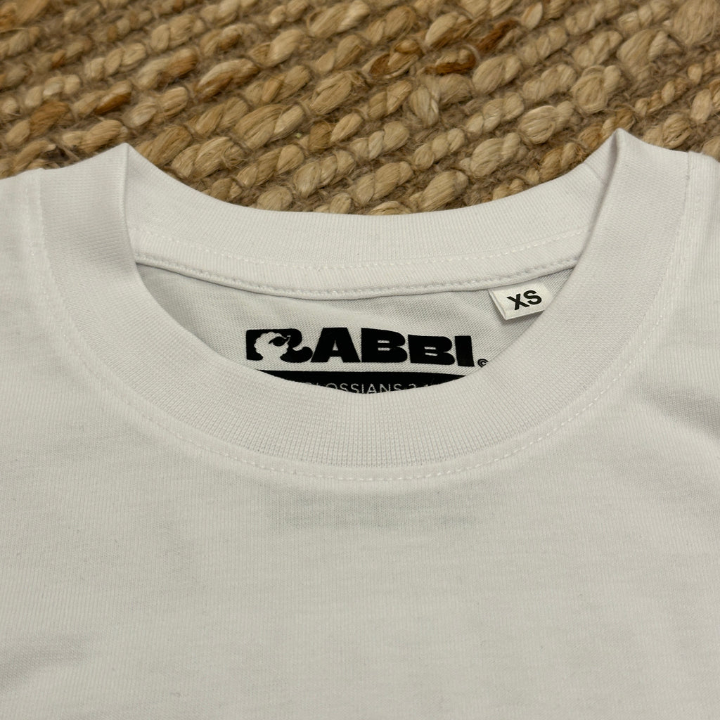 Baggy embroidered t-shirt label showing size XS and brand, showcasing quality fabric and design details.