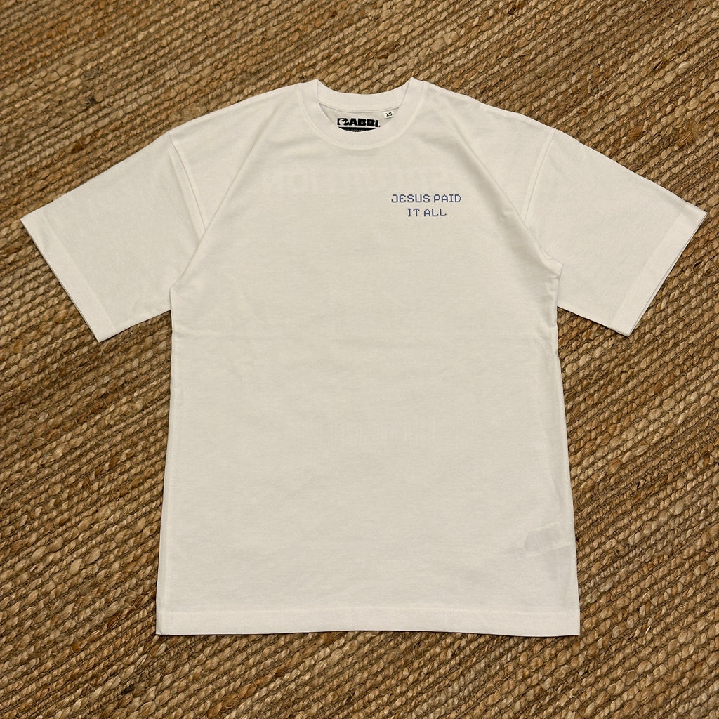 Baggy embroidered t-shirt in white with text 'JESUS PAID IT ALL' on the front, showcasing a relaxed fit and streetwear style.